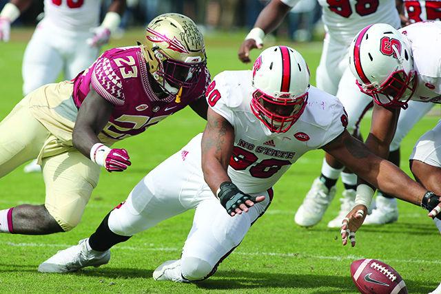 Graduate defensive end Mike Rose dives for the loose ball after sacking Florida State quarterback Everett Golson and forcing the fumble. Rose recovered the fumble at the 10-yard line, setting up the field goal for NC State to jump out to an early 3-0 lead.