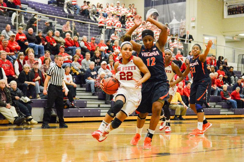 Junior guard Dominique Wilson dribbles down the court around several Virginia players. Wilson led the team with a total of 24 points this game and ecclipsed 1000 points in her overall career. The team had a win over Virginia of 63-52 in holliday Coliseum at Broughton High School on Wednesday, Jan. 27 2016.