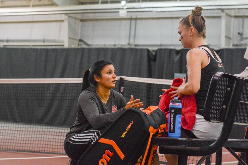 Assistant Coach Gina Suarez-Malaguti offers advice to Martina Frantova between sets. Frantova won in 2 sets, 6-3, 6-1, helping State to an overall victory of 4-2 against East Carolina University on Mon., Januay 25th, 2016 at J.W. Isenhour Tennis Center.