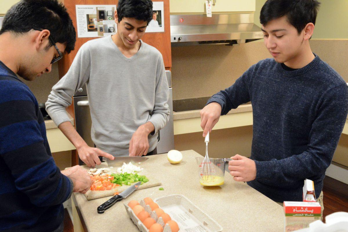 Yash Mathradas, a sophomore and studying Business Management and Ahmed Said Al Mahrooqi, a Sophomore studying Computer Science, prep up the ingredients for an Omani dish while Mauricio Ivan Carrillo, a sophomore studying Accounting helps them out. Mathradas am Said Al Marooqi are Omani International students here at NC State and Carrillo is an American. Yash; Ahmed and Mauricio are part of the Global Village program at Alexander Hall; like many other residents in that dorm .Alexander Hall predominantly houses a large community of International students along with American students interested in meeting and learning about different cultures and people from all over the world. Alexander Hall has a very well equipped kitchen in their basement; where people can easily prepare their native cuisines and share it with others.