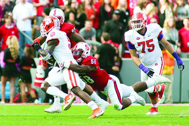 Sophomore linebacker Airius Moore makes a flying tackle on No. 3 Clemson's runningback Wayne Gallman. Moore had nine tackles, two for a loss totalling three yards. The Wolfpack lost the homecoming game 56-41 in Carter-Finley Stadium on October 31st.