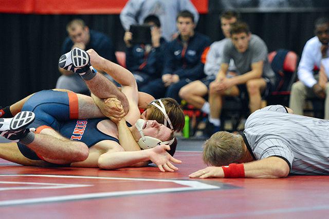 Junior Max Rohskopf holds his opponent down while the official gets a close look in the Wolfpack's win over No. 17 Virginia on Jan. 17. Rohskopf won his bout and helped the Wolfpack to a 35-7 win at Dorton Arena.