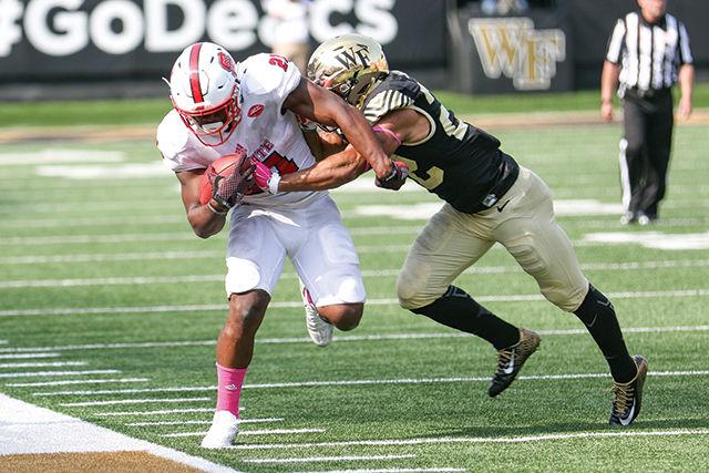 Junior runningback Matt Dayes tiptoes along the sidelines before being pushed out of bounds by a Wake Forest defender. Dayes led the team with 16 carries for 205 yards. The Wolfpack dominated Wake Forest in the 35-17 win at BB&amp;T field in Winston Salem on October 25th.
