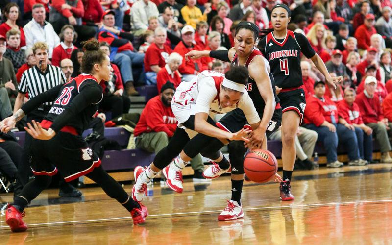 Junior guard Miah Spencer trips and loses the ball while running through the Louisville defense in the second half. Spencer had four rebounds and 14 points in a foul heavy game which had 4 Wolfpack members fouled out and 6 fouled out overall. The Wolfpack put up a valiant effort but came away with a heartbreaking 92-90 loss to Louisville in the final seconds after leading for 36 minutes in Broughton High School's Holliday Gymnasium on January 17th.
