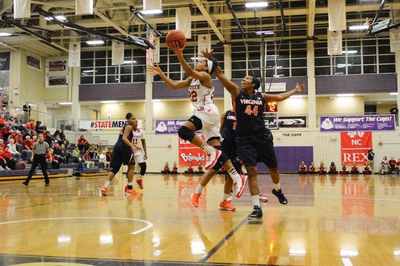 Junior guard Dominique Wilson goes for a layup with several opposing Virgina players directly behind. Wilson led the team to victory rounding up 24 points during the entire game. The womens basketball team had a win over Virginia of 63-52 in Holliday Gymnasium at Broughton High School on Wednesday Jan. 27 2016.