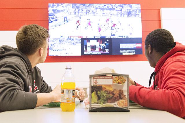 Maxwell Myers, a freshman studying polymer and color chemistry, watches the N.C. State basketball game against Pitt with Ameer Desilba, sophomore studying paper science engineering, on Janurary 19th in Talley Student Union. "I watch about three games a week in Talley" said Desilba.