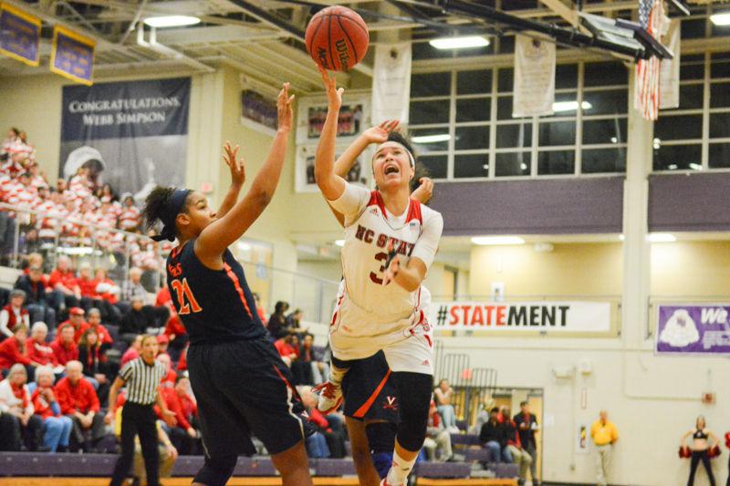Junior guard Miah Spencer attempts a two point shot with the defensive Virginia players alongside. Spencer surpassed 1000 points in her overall career during the game. The womens basketball team won over Virginia with a final score of 63-52 in Holliday Gymnasium at Broughton High School on Wednesday, Jan. 27 2016.