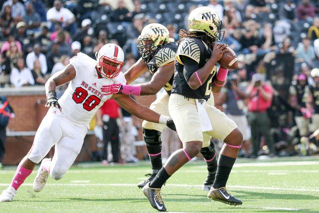 Graduate student defensive end Mike Rose pressures the Wake Forest backup quarterback. Rose finished with three sacks for a total loss of 20 yards. The Wolfpack came back from a bye week to win 35-17 on Oct. 24 in BB&amp;T field at Wake Forest.
