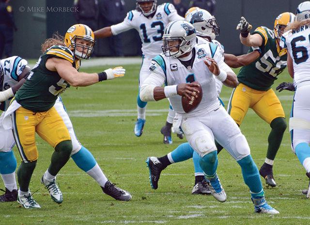 Carolina Panthers' Quarterback Cam Newton avoids a tackle from Green Bay Packers' Linebacker Clay Matthews. Newton has led the Panthers to a 15-1 record this season.&#160;