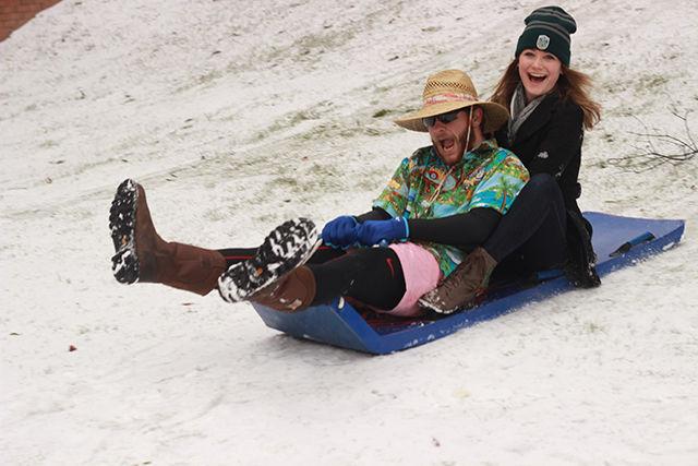 Lexi Weidmann, a freshman majoring in business, along with Trevor Graham, a freshman majoring in sustainable materials and technology, have a fun time skiing near D.H. Hill library on a snow-filled Saturday.