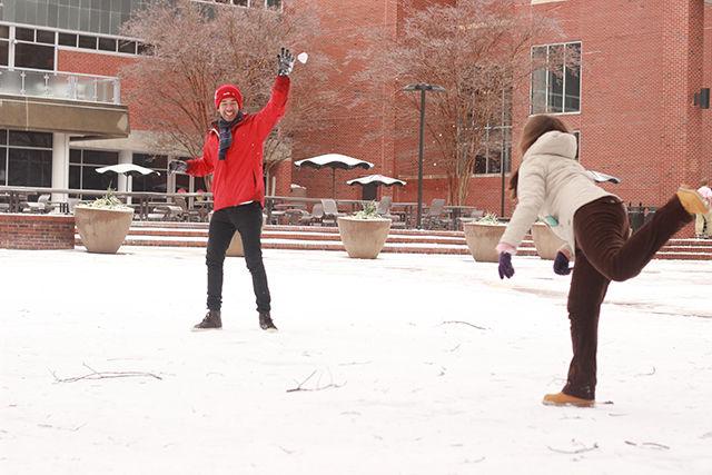 Alexandre Felipe Lima, a junior majoring in Biotechnology tries to catch a snowball that his friend threw at him. They were having a snowball fight at the Brickyard.