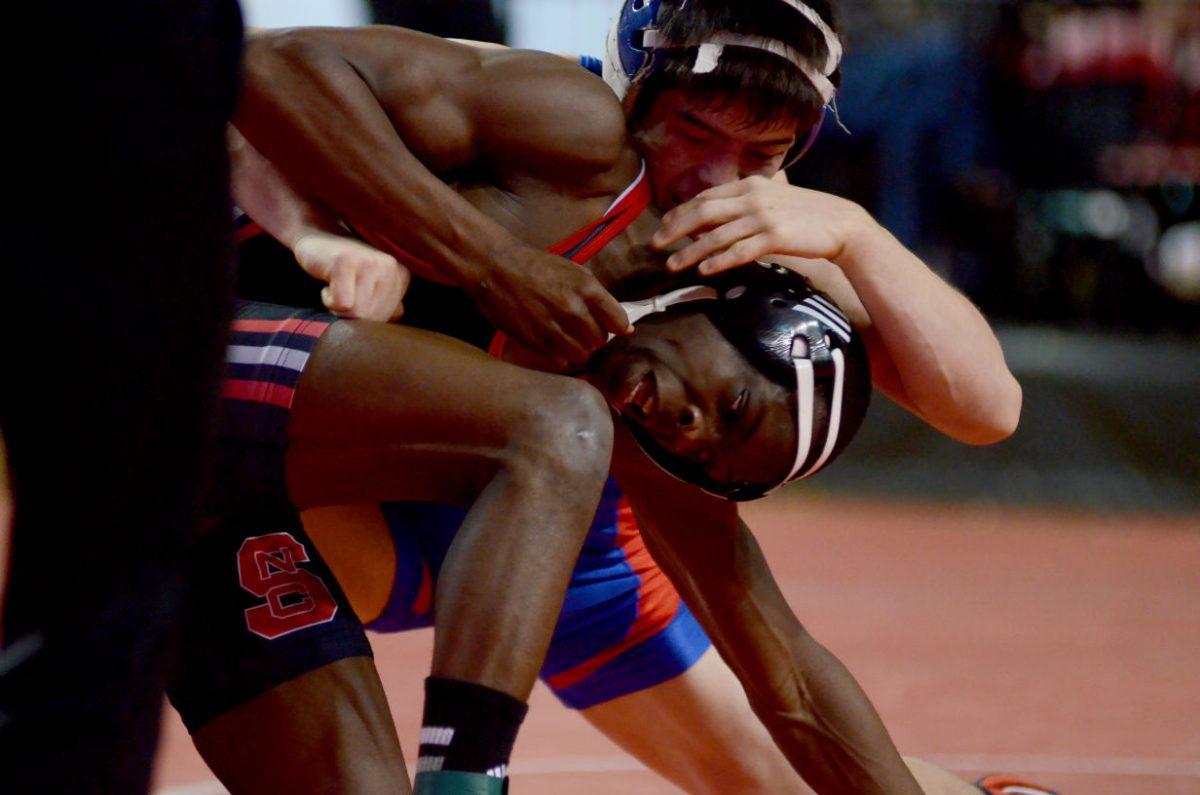 Wrestling in the 149-lb weight class, sophomore Thomas Gantt tries to break free from American University's Kevin Tao's hold Friday, Jan. 17, 2013. Gantt fell to Tao 7-3 by decision in the Wolfpack's 24-16 loss to the Eagles at Reynolds Coliseum.