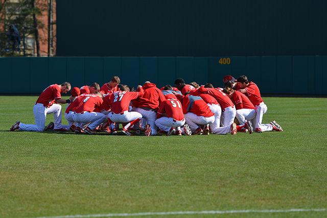 The baseball team gathers on the field prior to the start to pray. The team went on to win 6-1 against Wright State University at Doak Field at Dail Park on Saturday, Feb 27, 2016.
