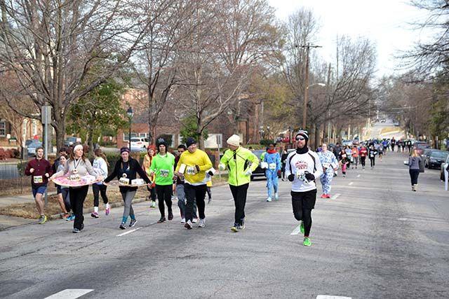 Participants of the Krispy Kreme Challenge continue running after they have either picked up or ate their dozen doughnuts outside of the Krispy Kreme on N. Persons St. on Saturday, Feb. 6th, 2016.