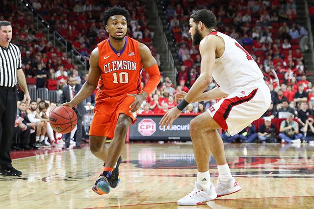 A Clemosn guard looks to pass during the Clemson vs NC State basketball game at PNC Arena on February 20, 2016.