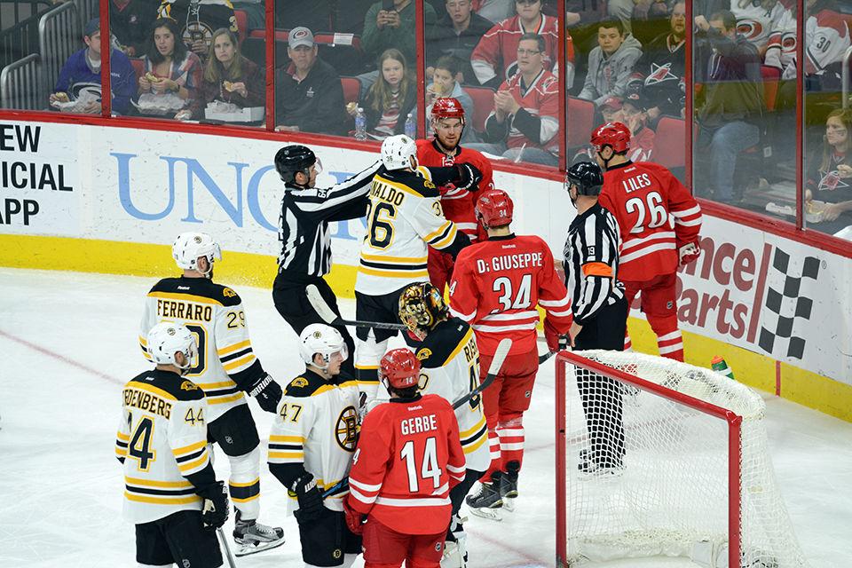 Carolina Hurricanes center forward Brad Malone and Boston Bruins center forward Zac Rinaldo have to be separated by the referees during the second period of the game on Friday, Feb 26, 2016.