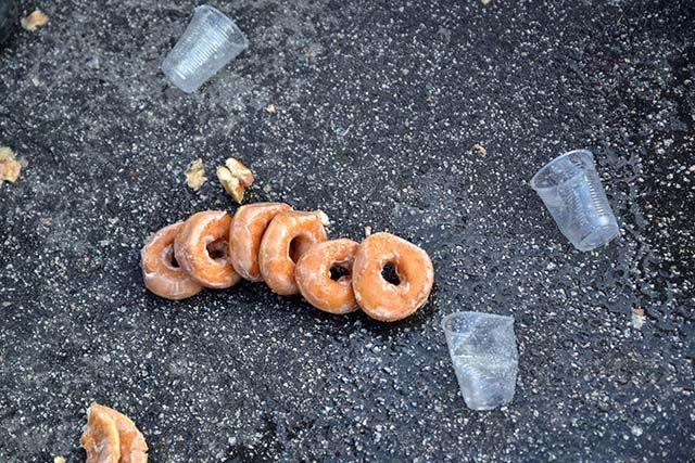 Half a dozen doughnuts lie on the ground in the middle of N. Persons Street oustide of the Krispy Kreme during the Krispy Kreme Challenge on Saturday, Feb. 6th, 2016.