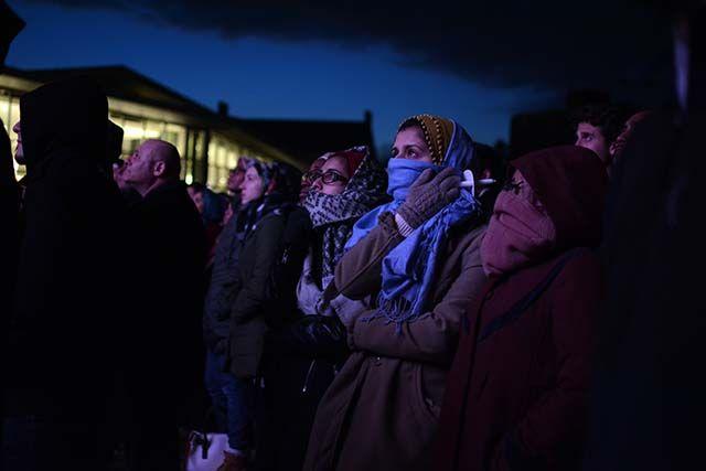 Ayesha Ziaulla, Manahil Agha and Mariya Husain watch a short video on the Three Winners' contribution to society before Chancellor Woodson spoke at the memorial on Feb 10, 2016 on Stafford Commons outside Talley Student Union.