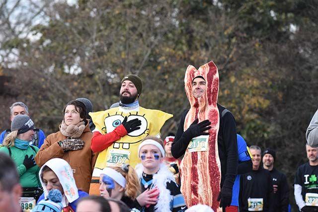 Jonathan Pierce, an NC State alumni '12, and Ian Pierce stand during the playing of the National Anthem for the Krispy Kreme Challenge. The Krispy Kreme Challenge had around 7000 registered runners and raised $195,000.
