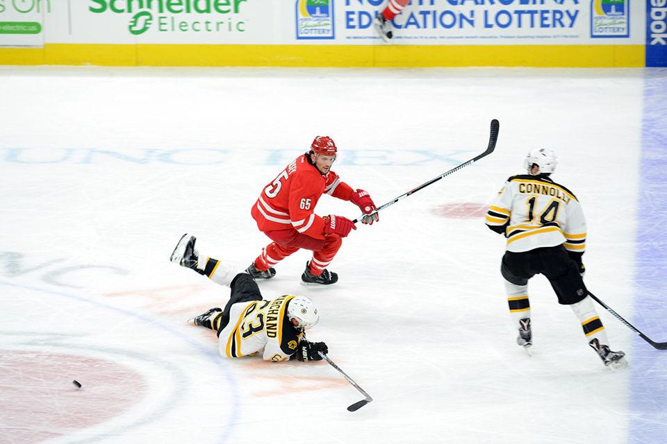 Carolina Hurricanes defenseman Ron Hainsey receives a two minute penalty after tripping Boston Bruins Brad Marchand during the ice hockey game at PNC Arena on Friday, Feb 26, 2016.