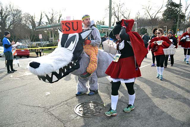Tom Place, an NCSU alum, and Jessie Kadolph run the Kripsy Kreme Challenge dressed as a wolf and Little Red Riding Hood on Saturday, Feb. 6th, 2016. Place has completed the challenge every year, for the past 11 years.