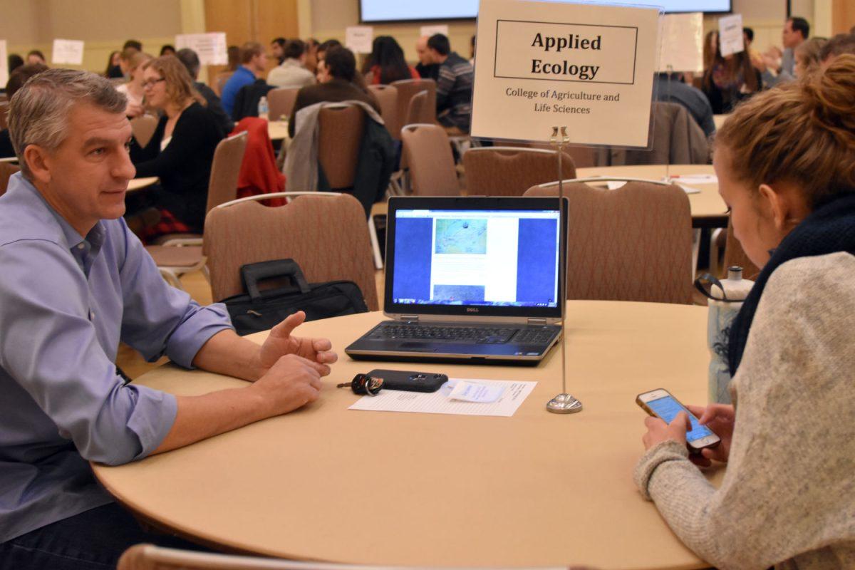 Allison Schumacher, a sophomore studying zoology, chats with Dr. Craig Layman about future opportunities in research.