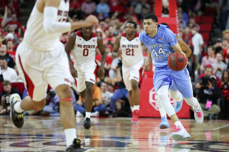 Justin Jackson sprints down the court with the ball in the second half and passes it to a teammate. The NC State Wolfpack lost to the UNC tarheels, 80-68, at PNC Arena on February 24, 2016.
