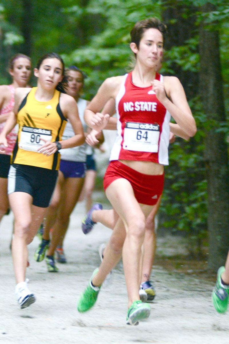 Freshman Joanna Thompson runs out of the woods during the Adidas Cross Country Challenge at Wake Med Soccer Park on Sept. 16, 2011. She would go on to finish third.