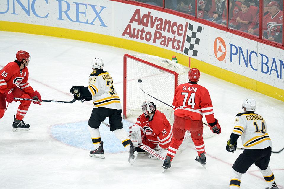 Patrice Bergeron, center forward for the Boston Bruins, scores the first goal on goalie Cam Ward just after ten minutes of the first period on Friday, Feb 26, 2016. The Bruins defeated the Carolina Hurricanes 4-1 at the PNC Arena.