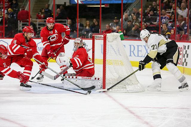 Jay McClement and goalie Cam Ward stop a great attempted shot by a Penguin Centre Malkin. Ward had 23 saves and gave up two goals. The Carolina Hurricanes squeezed out a narrow victory in overtime 3-2 against the Pittsburgh Penguins at PNC Arena on January 12th, 2016.