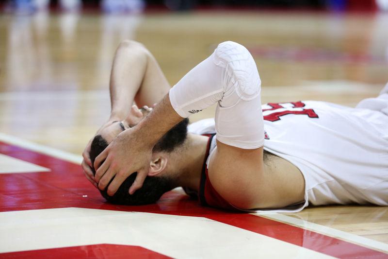 Cody Martin falls to the ground in disbelief in the second half. The NC State Wolfpack lost to the UNC tarheels, 80-68, at PNC Arena on February 24, 2016.