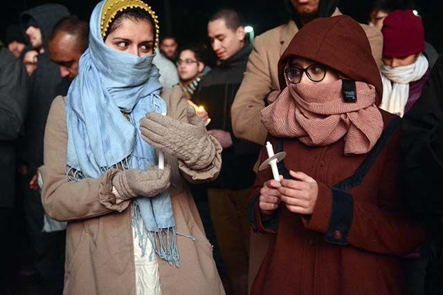 Manahli Agha, studying public policy and Mariah Husain, studying biology both are juniors UNC-Chapel Hill. Agha and Husain gathered in Stanford Commons for the candlelight vigil, on Feb. 10th, 2016, for Deah Barakat, Yusor Abu-Salha and Razan Abu-Salha.