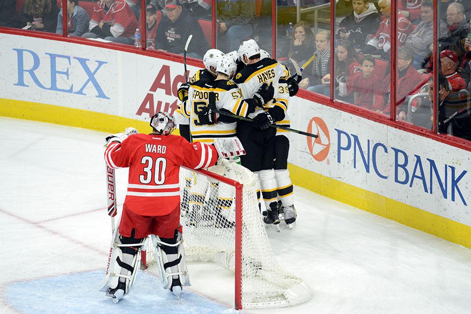 The Boston Bruins celebrate after their second goal against Carolina Hurricanes goalie Cam Ward on Friday, Feb 26, 2016.