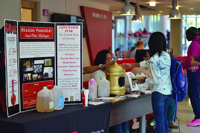 Jade Smith, a junior studying nutrition science, donates her change to the penny wars competition hosted by the National Pan Hellenic Council. The money is going towards water bottles and water filters for those in Flint, MI. When asked why she donated, Smith said "I just saw the flyer out and wanted to donate and thought it was a good cause."