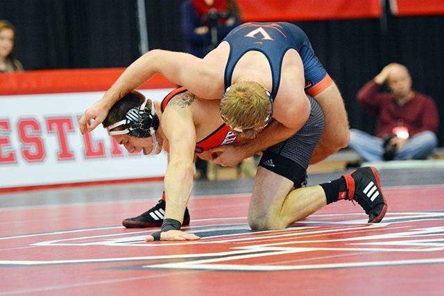 Sophomore Nicky Hall holds on as his opponent flips over him in the Wolfpack's meet against No. 17 Virginia. Hall won his bout 17-2 on a technical fall, which helped the Wolfpack to an overall 35-7 win at Dorton Arena Jan. 17.