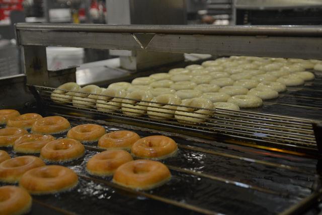 This part of the Krispy Kreme machine flips the doughnuts over to ensure that they are cooked equally on both sides.