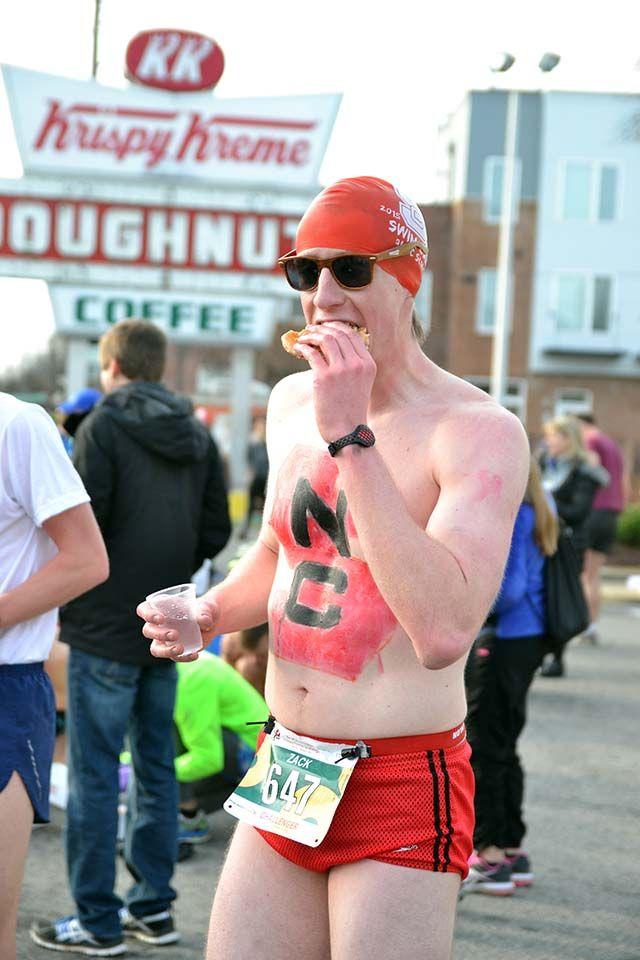 Zachary Goodman, a senior studying mechanical engineering and a member of NCSU's Swim Club, eats doughnuts during the middle of the Krispy Kreme Challenge outside of Krispy Kreme on Saturday, Feb. 6th, 2016.