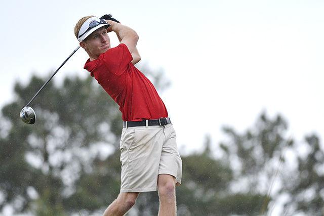 Junior David Cooke drives on the 18th hole at the Wolfpack Spring Open on Sunday afternoon. Cooke was the overall champion of the tournament with a score of -10 and the Wolfpack finished first with -17 at Lonnie Poole Golf Course on Sunday.