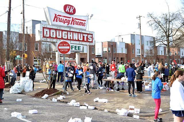 Krispy Kreme Challenge participants stand around eating their dozen doughnuts at Krispy Kreme on N. Persons St. during the Krispy Kreme Challenge on Saturday, Feb. 6th, 2016.