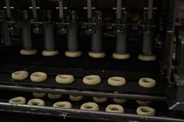The Krispy Kreme Doughnut machine automatically cuts the dough to be cooked into the circle shape they exhibit. The machine will cut 400 doughnuts in an hour, equalling 9,600 doughnuts a day.