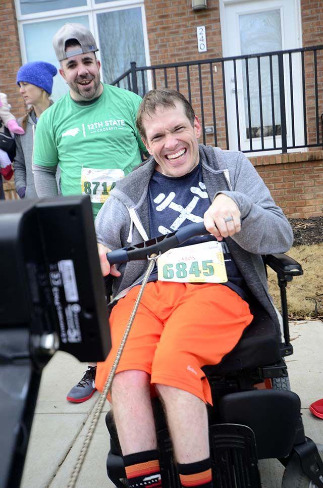 Rich Bolza, citizen of raleigh, cheers on Jason Reynolds, citizen of raleigh, during the 2016 Krispy Kreme Challenge on Feburary 6th. This year's challenge had 7,000 registered runners and raised more than $190,000. Reynolds participated in this years event on a rowing machine and finished the race in 55 minutes and nine seconds.