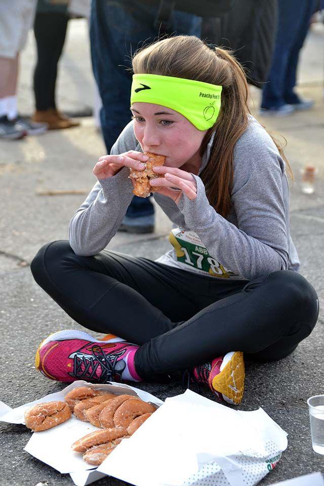 Abigale Verchick, a sophomore in life sciences, is one of the first women to pass the halfway point of the Krispy Kreme Challenge on Saturday, Feb 6th, 2016. Verchick jumped on her box to flatten the doughnuts and make them easier to eat outside of the Krispy Kreme on N. Persons St.