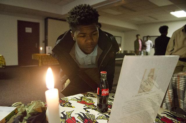 Miles Leathers, a member of the Black Male Intiative Group, looks at a table honoring a soldier the Visualization room during the 2016 Blacks in Wax Tour on Feburary 20th. The Visualization room honors African Americans who have died as a result of racisim. "African Americans have a rich history and culture" said Leathers. "Throughout history we have been opressed see but we have come up from it. We still have allot to do."