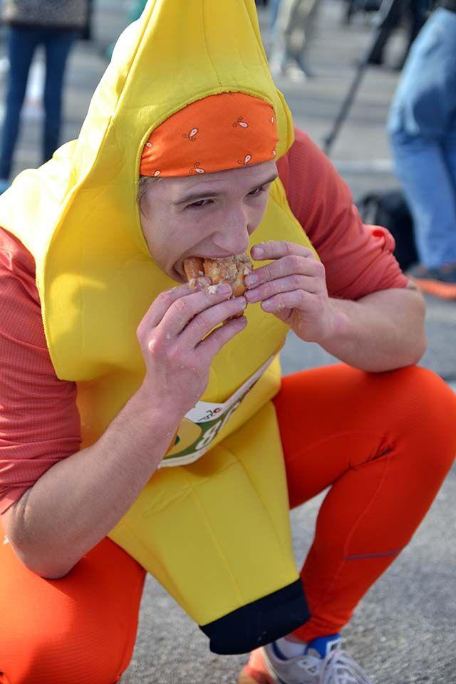 Brock Johnston, a junior at Leesville Road High School, stuffs multiple doughnuts into his mouth during the 12th Annual Krispy Kreme Challenge outside of Kripsy Kreme on N. Persons St. The race is five miles long broken up by eating a dozen doughnuts in the middle of the race.