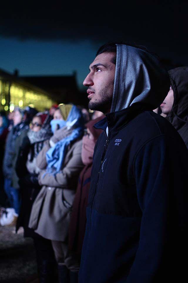Raza Samimy, a student at University of North Carolina, Chapel Hill watches a video on the contributions that Deah, Yusor and Razan made to society. "We have also done events like this at Chapel Hill and we're trying to support the community around us."