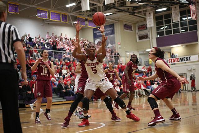 Sophomore forward Chelsea Nelson stretches for a rebound while boxing out Florida State's defense. Nelson had ten points and a team-high eight rebounds during her 28 minutes of play. The Pack suffered a late game loss to No. 12 Florida State 56-52 in Holliday Gymnasium at Broughton High School on Feb. 25.
