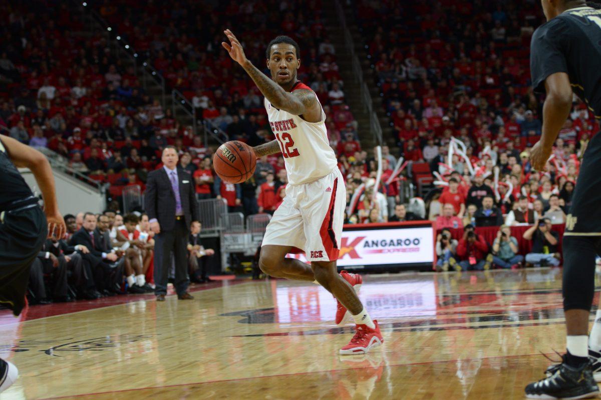 Junior guard Cat Barber dribbles the ball while he looks up for a teammate or a shot at the basket. Barber beat his own personal record of 37 points at the Wake Forest basketball game Saturday at PNC Arena by scoring a total of 38 points.