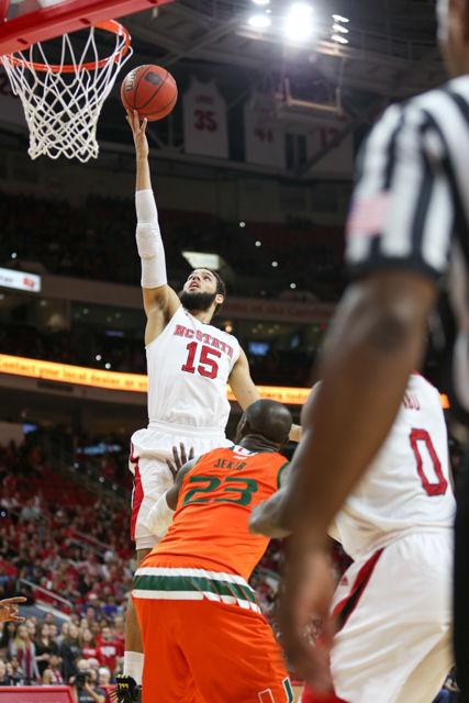 Sophomore guard/forward Cody Martin elevates over Miami defenders towards the rim for a layup in the second half. Cody Martin finished the game with eight points on 3-4 shooting including four assists and a rebound. The Wolfpack beat the Miami Hurricanes 85-69 on January 30th, 2016 at PNC Arena.