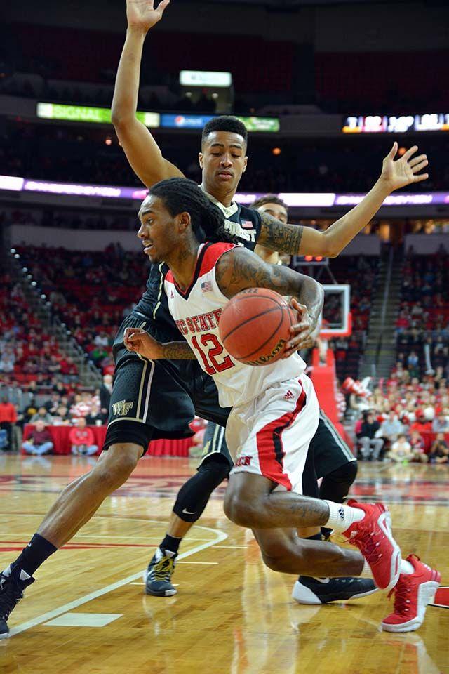 Junior guard Anthony "Cat" Barber runs around freshman forward John Collins from Wake Forest to attempt to score during the basketball game on Saturday, Feb 13, 2016. Barber scored 38 out of NC State's 99 points, beating the Wake Forest's 88.