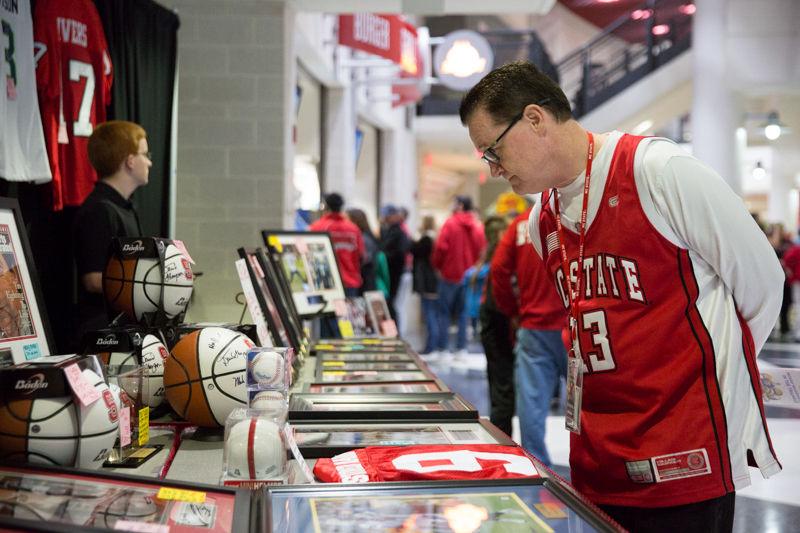 An NC State fan looks at some signed memorabilia before the NC State game versus UNC at PNC Arena on February 24, 2016.